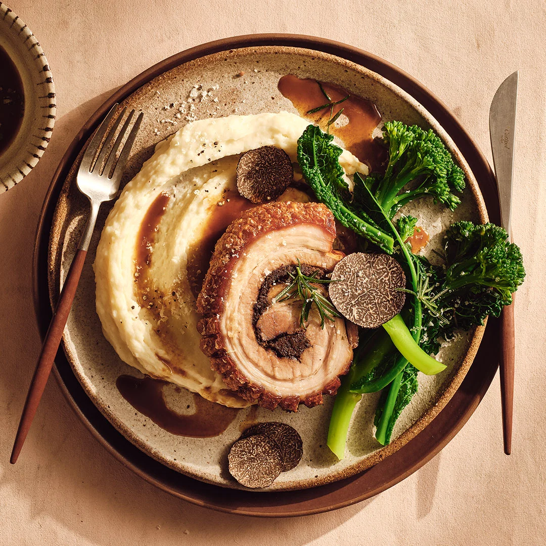 Gourmet Traveller Unveils a Masterpiece: The Black Garlic Porcini Porchetta with Truffle Manchego Mash